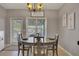 Dining area features a modern chandelier, decor, and view to covered porch at 542 Broughton Dr, Canton, GA 30114