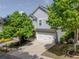 Charming two-story home with a two-car garage, nice landscaping, and a long driveway at 542 Broughton Dr, Canton, GA 30114