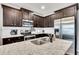 Close-up of a modern kitchen featuring granite countertops, a stainless steel sink, and sleek appliances at 542 Broughton Dr, Canton, GA 30114