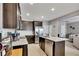 Bright kitchen featuring granite countertops, stainless steel appliances and dark wood cabinets at 542 Broughton Dr, Canton, GA 30114
