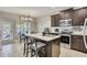 Modern kitchen with granite countertops, dark wood cabinets, stainless steel appliances and large island at 542 Broughton Dr, Canton, GA 30114