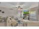 Bright living room with a large sectional sofa, plush carpet, and a decorative ceiling fan at 542 Broughton Dr, Canton, GA 30114