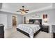 Spacious main bedroom with tray ceiling, fan, and ensuite bathroom at 542 Broughton Dr, Canton, GA 30114