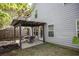 Relaxing patio with pergola, perfect for outdoor dining and enjoying the serene backyard at 542 Broughton Dr, Canton, GA 30114