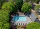 Aerial view of a community pool surrounded by lush greenery and lounge chairs, perfect for relaxation at 542 Broughton Dr, Canton, GA 30114