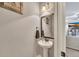 Comfortable powder room with pedestal sink and decorative mirror at 542 Broughton Dr, Canton, GA 30114