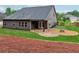 Spacious backyard with a covered patio, gravel fire pit, perfect for outdoor entertaining at 6340 Arlington Cir, Cumming, GA 30041