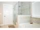 Modern bathroom featuring a glass enclosed shower with decorative tilework and a separate soaking tub at 6340 Arlington Cir, Cumming, GA 30041