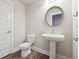 Chic powder room with pedestal sink and modern fixtures at 6340 Arlington Cir, Cumming, GA 30041