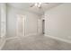 Cozy bedroom with plush carpeting, a doorway to a walk-in closet, and ample natural light at 6340 Arlington Cir, Cumming, GA 30041