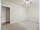 Carpeted bedroom with neutral walls and trim, leading to an adjoining room at 6340 Arlington Cir, Cumming, GA 30041