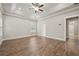 Spacious bedroom featuring tray ceilings, a ceiling fan, and natural light at 6340 Arlington Cir, Cumming, GA 30041
