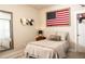 Cozy bedroom featuring a comfortable bed, decorative flag, and ample natural light at 6340 Arlington Cir, Cumming, GA 30041