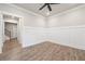 Versatile room with hardwood floors and wainscoting, suitable for a home office or playroom at 6340 Arlington Cir, Cumming, GA 30041