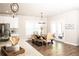Dining area featuring a wooden table, bench seating, and a view into the bright living space at 6340 Arlington Cir, Cumming, GA 30041