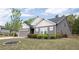 Charming home with gray siding, white trim, a well-manicured lawn, and a two-car garage at 6340 Arlington Cir, Cumming, GA 30041