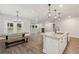 Bright kitchen island with granite countertops open to a dining area and fireplace living room at 6340 Arlington Cir, Cumming, GA 30041