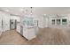 Open-concept kitchen with island, stainless steel appliances, and seamless flow to the living area at 6340 Arlington Cir, Cumming, GA 30041