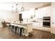 Spacious kitchen with white cabinetry, large island, stainless appliances, and modern pendant lights at 6340 Arlington Cir, Cumming, GA 30041