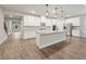 Bright kitchen with large island, stainless steel appliances, white cabinets, and contemporary design at 6340 Arlington Cir, Cumming, GA 30041