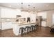 Bright, spacious kitchen with a large center island, stainless appliances, and stylish pendant lighting at 6340 Arlington Cir, Cumming, GA 30041