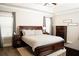 Serene main bedroom with a large bed, dark wood furniture, and neutral decor at 6340 Arlington Cir, Cumming, GA 30041