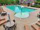 Community pool featuring a flower fountain, lounge chairs, and tables with umbrellas for residents' enjoyment at 6340 Arlington Cir, Cumming, GA 30041