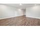 Spacious room featuring sleek hardwood floors, recessed lighting and neutral walls at 6340 Arlington Cir, Cumming, GA 30041