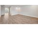 Spacious room featuring sleek hardwood floors, recessed lighting and neutral walls at 6340 Arlington Cir, Cumming, GA 30041