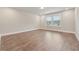 Bright room with hardwood floors and natural light streaming through windows at 6340 Arlington Cir, Cumming, GA 30041