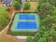 Aerial view of community tennis courts showcasing lush trees, professional lighting, and well-kept grounds at 6340 Arlington Cir, Cumming, GA 30041