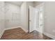 Walk-in closet with custom shelving and hardwood floors that connect to the bathroom at 6340 Arlington Cir, Cumming, GA 30041