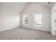 Bright, airy bedroom features two windows and plush carpet at 739 Rolling Downs Dr, Loganville, GA 30052