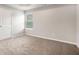 Bright bedroom with plush carpeting, neutral paint, and ample natural light at 739 Rolling Downs Dr, Loganville, GA 30052