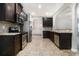 Well-equipped kitchen with stainless steel appliances, dark cabinets, and granite countertops at 739 Rolling Downs Dr, Loganville, GA 30052