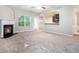 Cozy living room boasts fireplace, neutral paint, and an open layout to the kitchen at 739 Rolling Downs Dr, Loganville, GA 30052