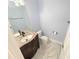 A powder room featuring a marble countertop, modern fixtures, and marble tile flooring at 1065 Brockton Close, Marietta, GA 30068