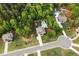 An aerial view of a home with a pool, nestled in lush green trees and lawns at 632 Creekside Trce, Covington, GA 30014