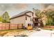 The house backyard has a grill area, stone path, screened porch, and a wooden fence at 632 Creekside Trce, Covington, GA 30014