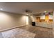 Finished basement area features a kitchenette with white cabinets and wood countertop at 632 Creekside Trce, Covington, GA 30014