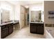 Bright bathroom features double vanities with granite counters and tile flooring at 632 Creekside Trce, Covington, GA 30014