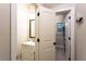 Bathroom with white cabinet vanity, open doorway, and a mirror hanging above sink at 632 Creekside Trce, Covington, GA 30014