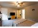 Bedroom with a ceiling fan, carpeting, and view into another room, adding versatility to the space at 632 Creekside Trce, Covington, GA 30014