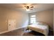 Cozy bedroom featuring a window, carpeting, and ample space for a comfortable living environment at 632 Creekside Trce, Covington, GA 30014