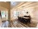 Well-lit dining area with wood-look flooring, modern light fixture, and views of the entry at 632 Creekside Trce, Covington, GA 30014