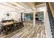 Open-concept dining area features a large table, unique light fixture, and wood-look floors at 632 Creekside Trce, Covington, GA 30014