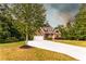 Charming two-story home with a well-maintained lawn, a tree in the yard and a long driveway at 632 Creekside Trce, Covington, GA 30014