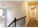 Hallway looking from the upstairs stairway, with a window and hallway lights at 632 Creekside Trce, Covington, GA 30014