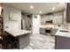 Kitchen with gray cabinets, stainless steel appliances, eat-in island, and decorative light fixtures at 632 Creekside Trce, Covington, GA 30014