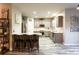 Bright kitchen features an eat-in island, stainless steel appliances, gray cabinets, and modern flooring at 632 Creekside Trce, Covington, GA 30014